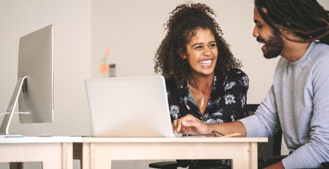 An employee works closely with a Flatiron instructor.